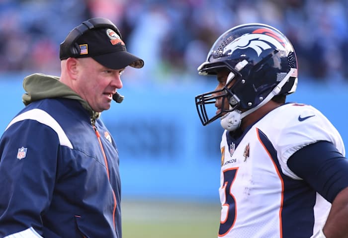 Denver Broncos head coach Nathaniel Hackett talks with quarterback Russell Wilson (3) during a timeout during the second half against the Tennessee Titans at Nissan Stadium.